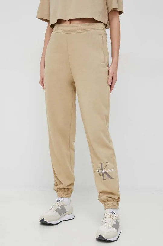 Tepláky Calvin Klein Jeans béžová
