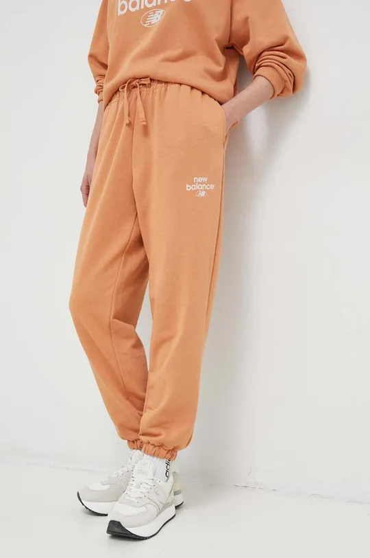 New Balance spodnie dresowe pomarańczowy