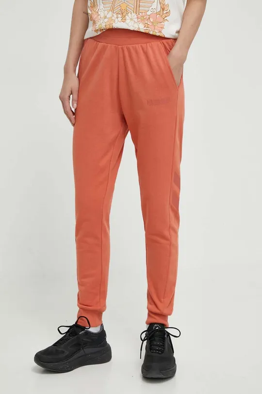 pomarańczowy Hummel spodnie dresowe hmlLEGACY WOMAN TAPERED PANTS Damski