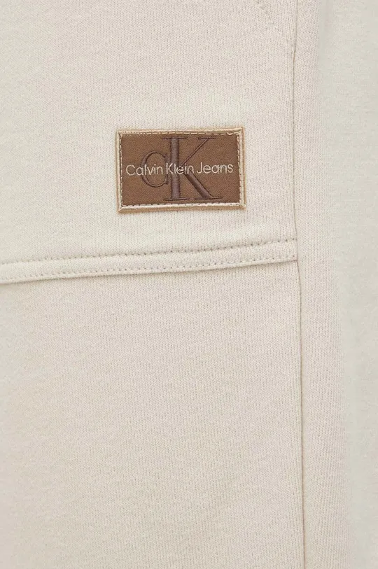 bež Bombažen spodnji del trenirke Calvin Klein Jeans