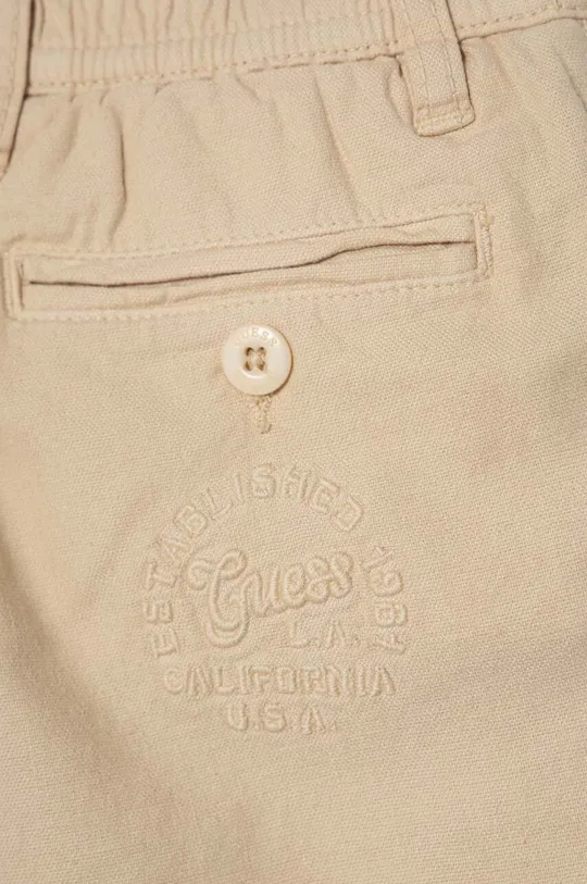 Dječje hlače s dodatkom lana Guess Temeljni materijal: 72% Pamuk, 25% Lan, 3% Elastan Podstava džepova: 100% Pamuk