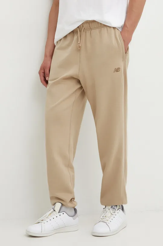 beżowy New Balance spodnie dresowe bawełniane MP41508SOT Męski