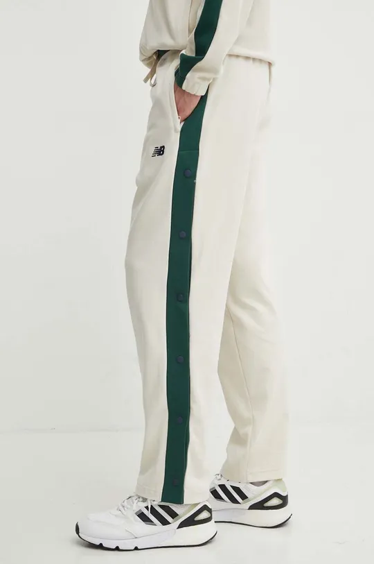 New Balance spodnie dresowe bawełniane MP41504LIN beżowy