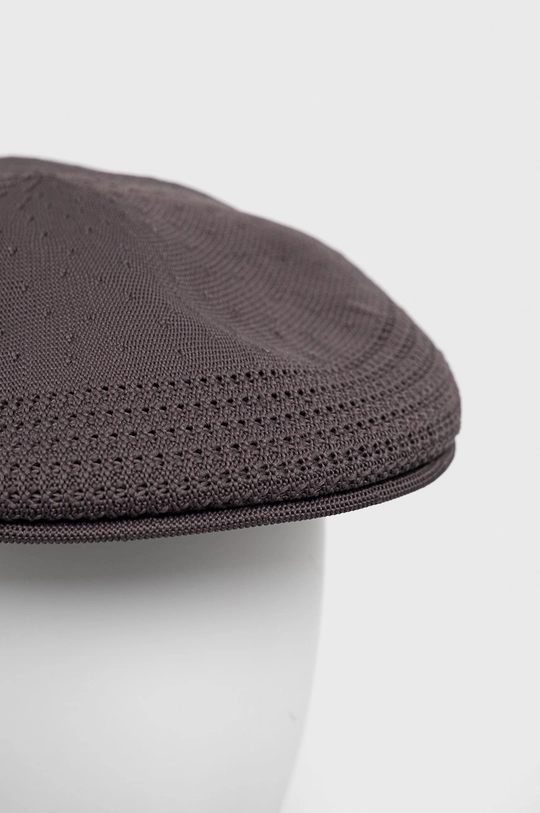 Kapa Kangol  Temeljni materijal: 30% Modakril, 70% Poliester Drugi materijali: 100% Najlon