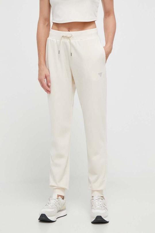 Guess spodnie dresowe COUTURE aplikacja beżowy V3BB27.KBXI2