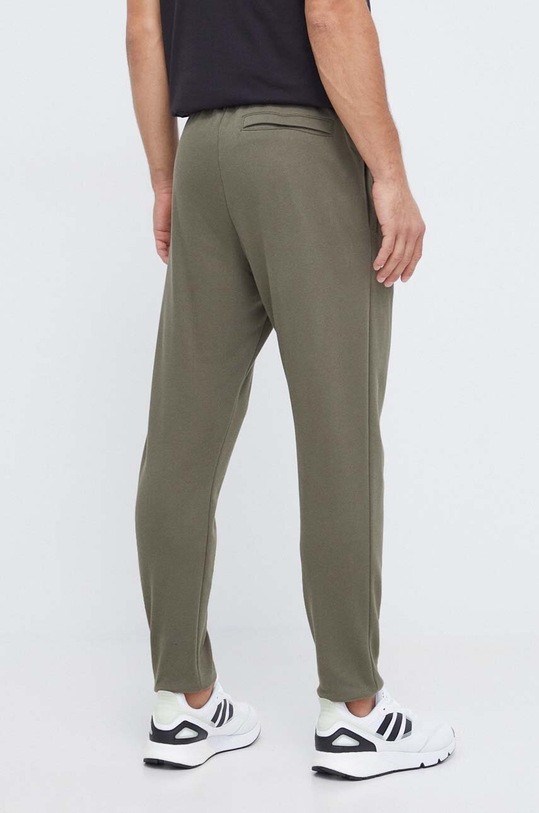Odzież Under Armour spodnie dresowe 1379774 zielony