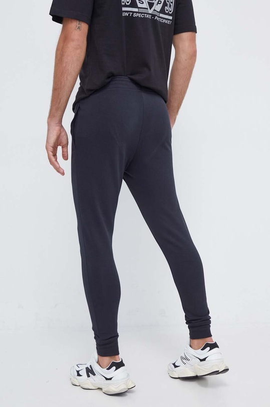 Odzież Under Armour spodnie dresowe 1380843 czarny