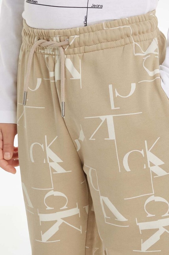 Дитячі бавовняні штани Calvin Klein Jeans TERRY JOGGER IB0IB02124.9BYH бежевий