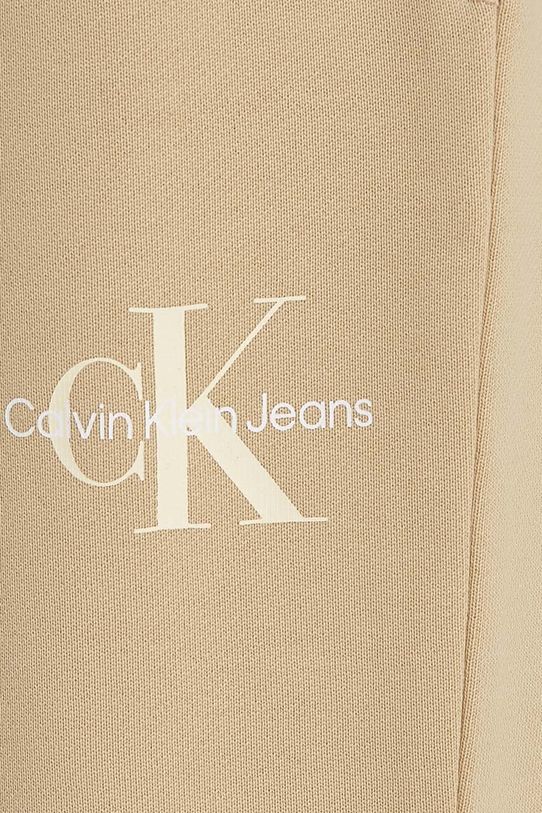 Chłopiec Calvin Klein Jeans spodnie dresowe bawełniane dziecięce MONOGRAM LOGO IU0IU00285.9BYH.128.176 beżowy