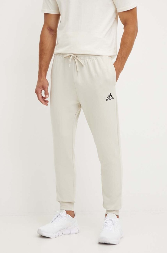 adidas spodnie dresowe Essentials dzianina beżowy JH1039