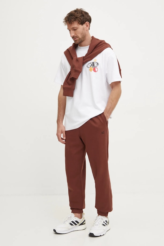 Bavlněné tepláky New Balance MP41508ROK hnědá AW24