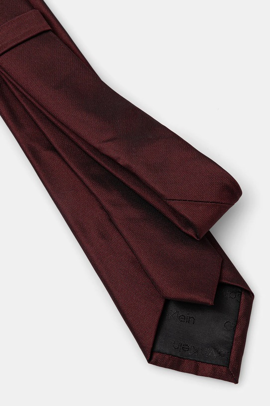 Calvin Klein krawat z dodatkiem jedwabiu CK2111E001 bordowy AW25