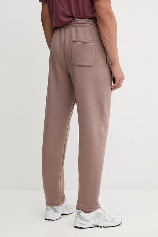 Odzież New Balance spodnie dresowe MP53508EAS brązowy