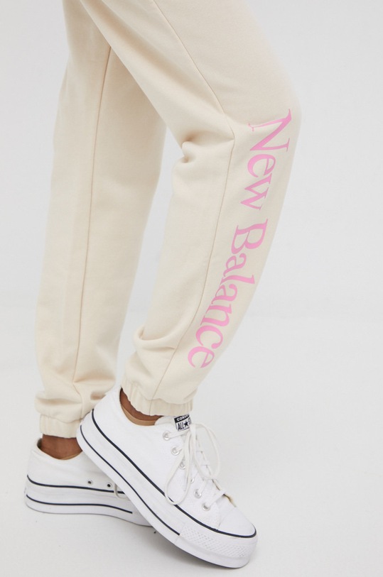 Odzież New Balance spodnie dresowe WP21508CTU WP21508CTU beżowy