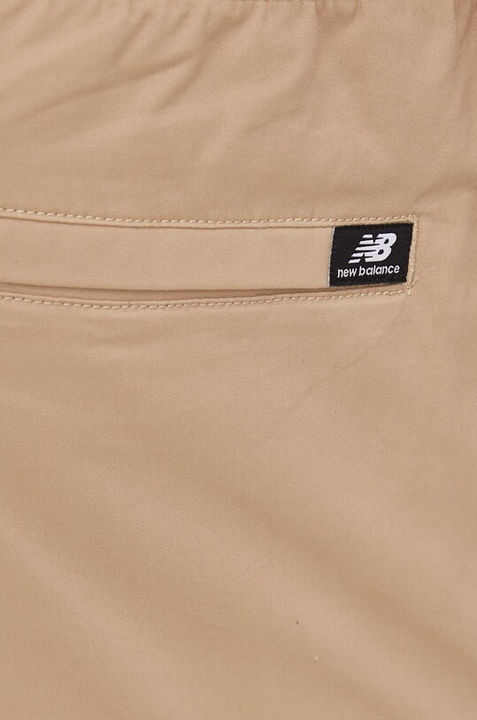 New Balance spodnie MP13501INC beżowy MP13501INC