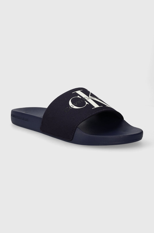 Natikači Calvin Klein Jeans SLIDE MONOGRAM CO YM0YM00061 mornarsko modra AW24