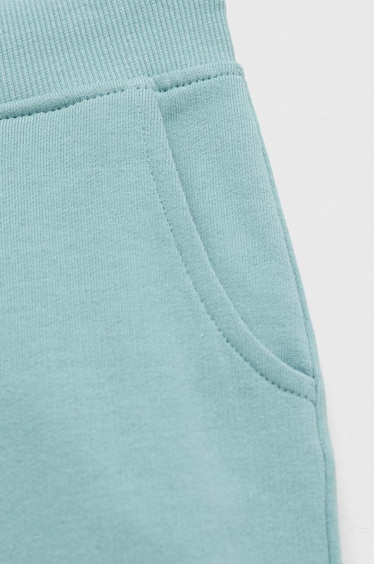 CHLAPEC Dětské bavlněné tepláky Guess L93Q24.KAUG0.PPYX tyrkysová