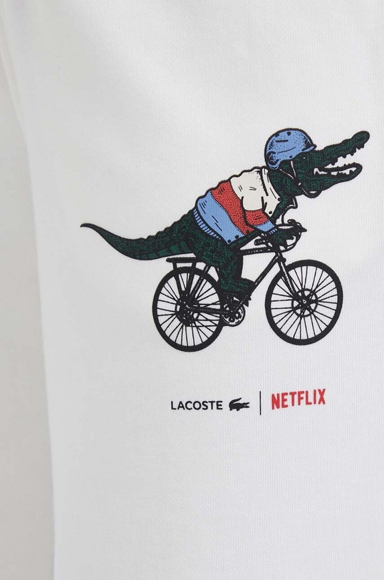 Pamučni donji dio trenirke Lacoste x Netflix bijela XF7335