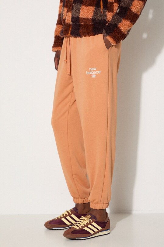 Tepláky New Balance oranžová WP31508SEI