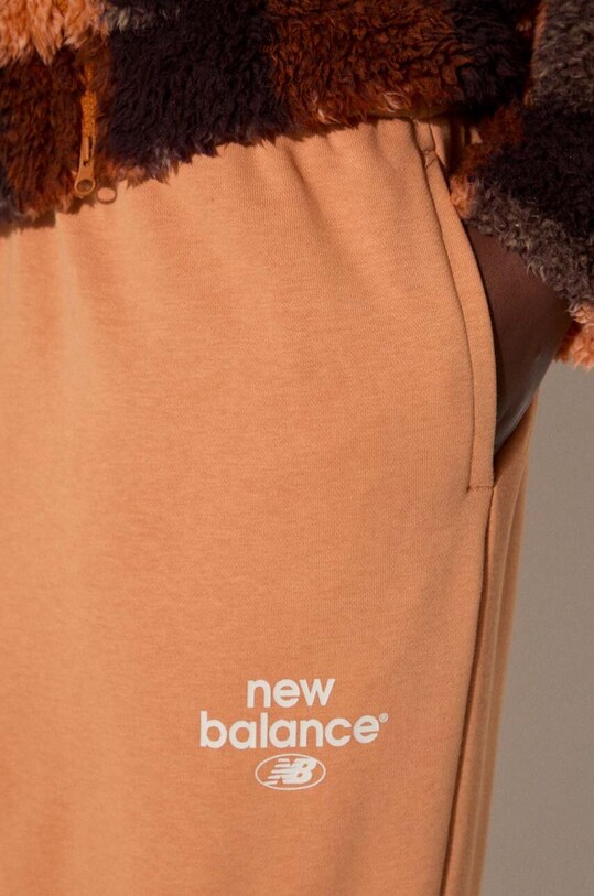 Tepláky New Balance WP31508SEI oranžová