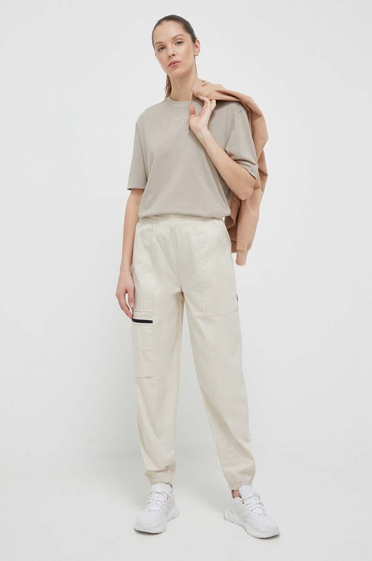 New Balance pantaloni WP31506TWF bej SS23