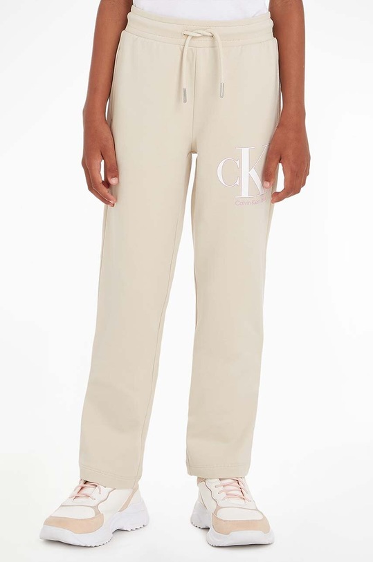 Dětské tepláky Calvin Klein Jeans potisk béžová IG0IG01985.PPYX
