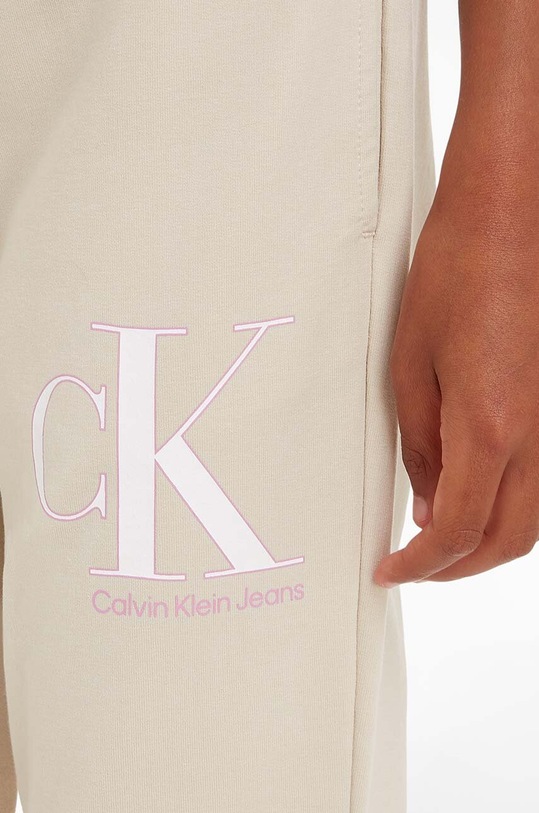 Dětské tepláky Calvin Klein Jeans IG0IG01985.PPYX béžová