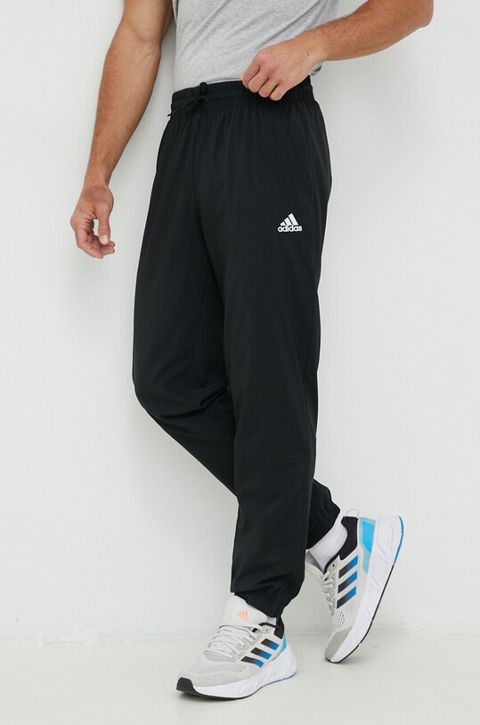 adidas spodnie treningowe Essentials tkanina czarny IC9424