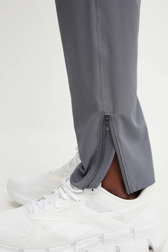 Běžecké kalhoty Under Armour Storm 1376800 šedá