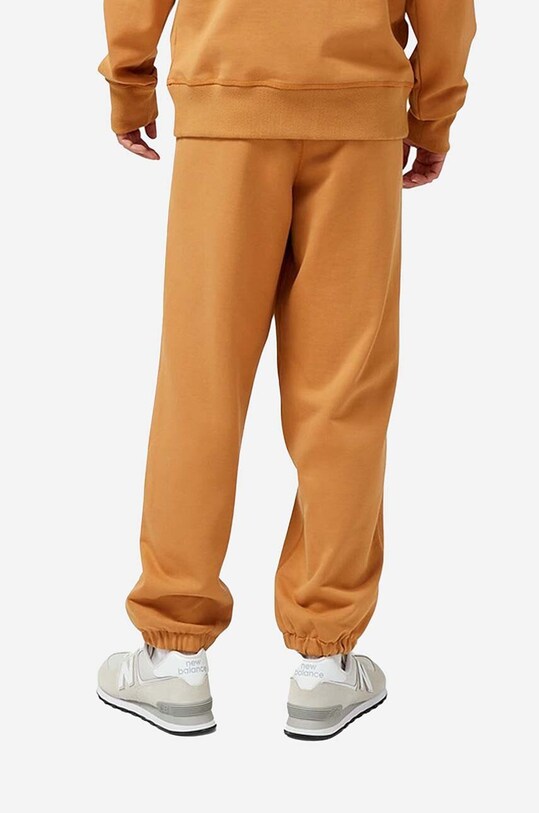 Oblečenie Bavlnené tepláky New Balance MP23551TOB oranžová