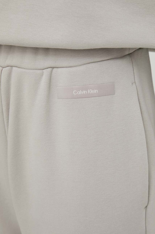 Tepláky Calvin Klein sivá K20K206632