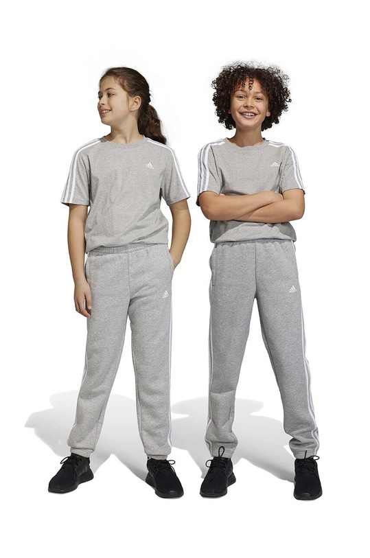 Dječji donji dio trenirke adidas pletivo siva IC0602