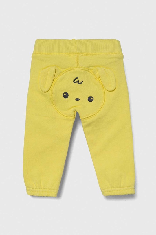 United Colors of Benetton spodnie dresowe bawełniane niemowlęce aplikacja żółty 3J70AF01L.W.Seasonal