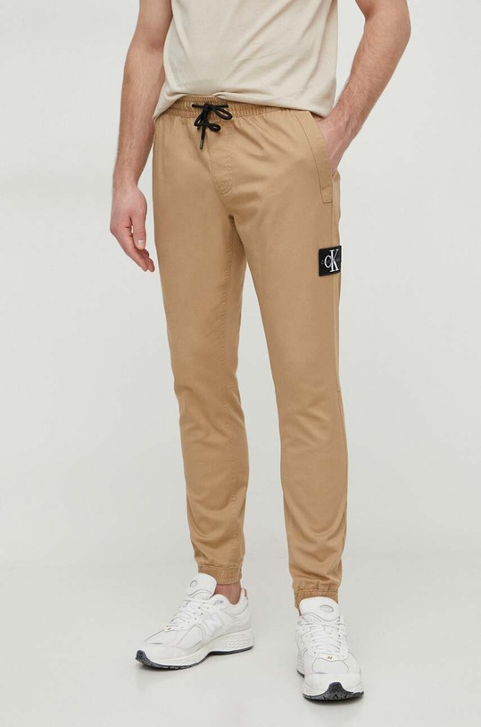 Nohavice Calvin Klein Jeans s elastanom béžová J30J325114