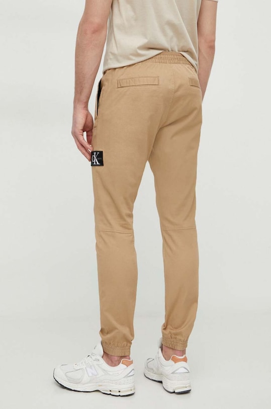 Oblečenie Nohavice Calvin Klein Jeans J30J325114 béžová