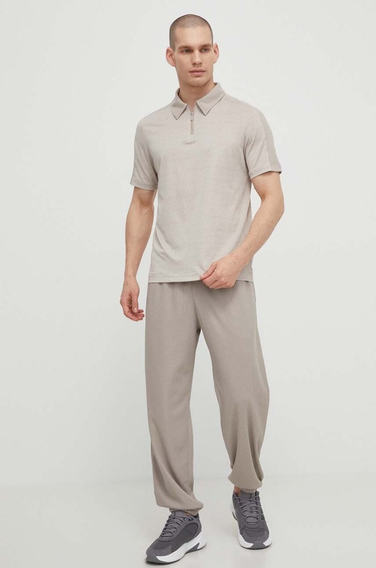 Tepláky Under Armour 1385932 béžová SS24