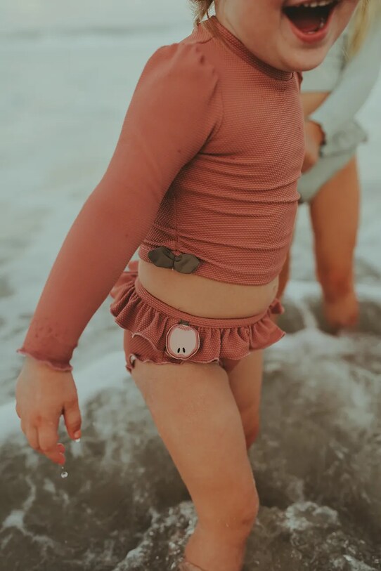 Παιδικό μαγιό μακρυμάνικο Donsje Nia Swim Shirt Apple μαλακό πορτοκαλί 4501401.68.92
