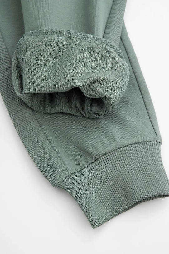 Otroški spodnji del trenirke Coccodrillo zelena WC5120101SBK