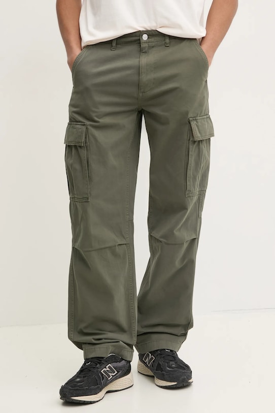 Бавовняні штани Tommy Jeans бавовна зелений DM0DM20293