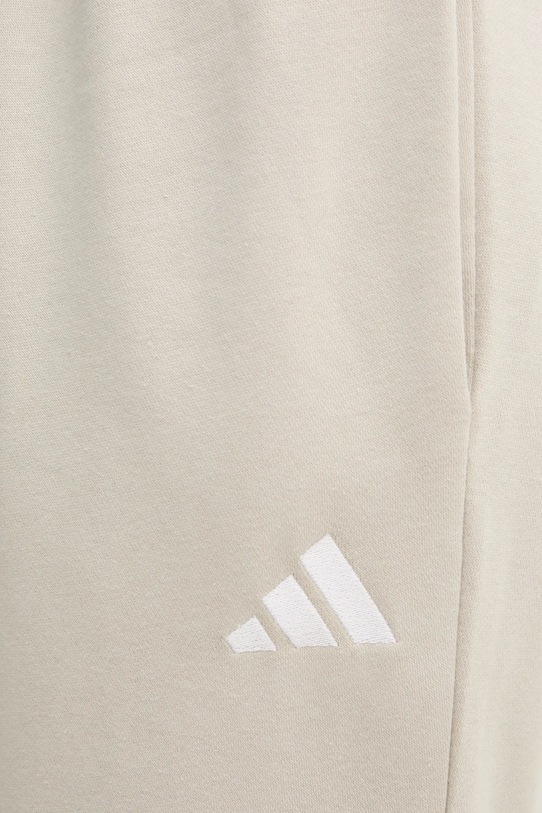 Tepláky adidas Feelcozy béžová IN6078