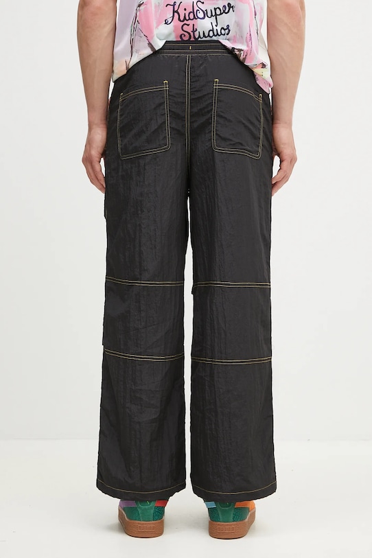 Odzież Puma spodnie dresowe PUMA x KIDSUPER Pants 629515 czarny