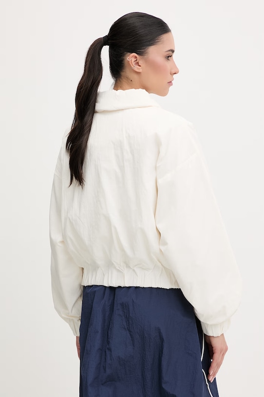 Ρούχα New Balance κοντό μπουφάν Γυναικείο Woven WJ61D8YXSST μπεζ