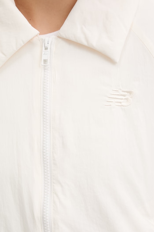 New Balance κοντό μπουφάν Γυναικείο Woven WJ61D8YXSST μπεζ