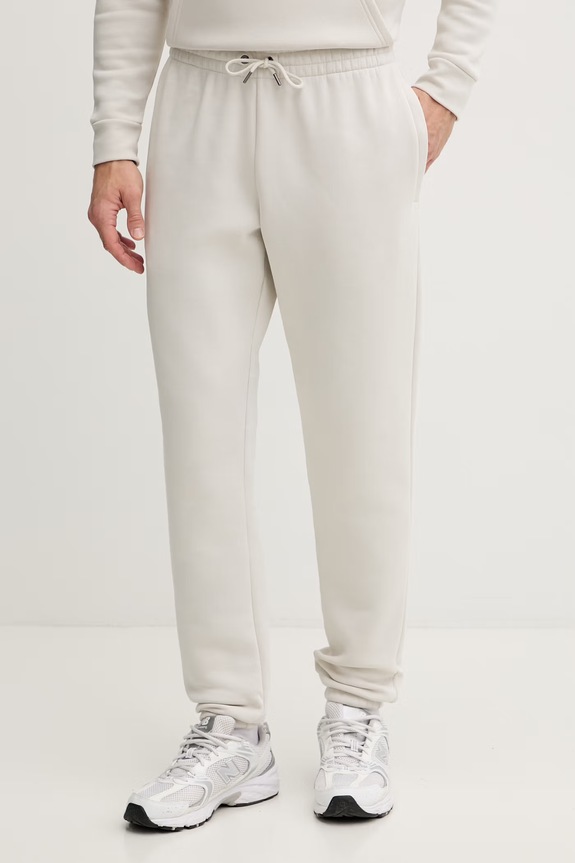 Under Armour spodnie dresowe męskie z bawełną Essential Fleece beżowy 1373882