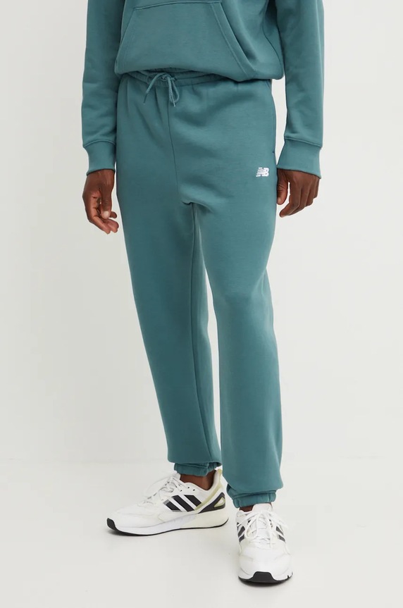 New Balance spodnie dresowe dzianina zielony MP41503NUS