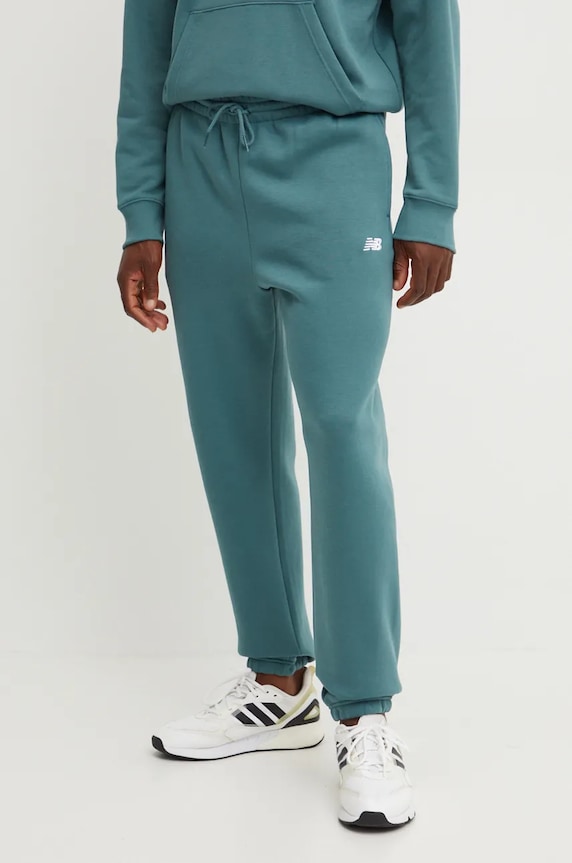 New Balance spodnie dresowe dzianina zielony MP41503NUS