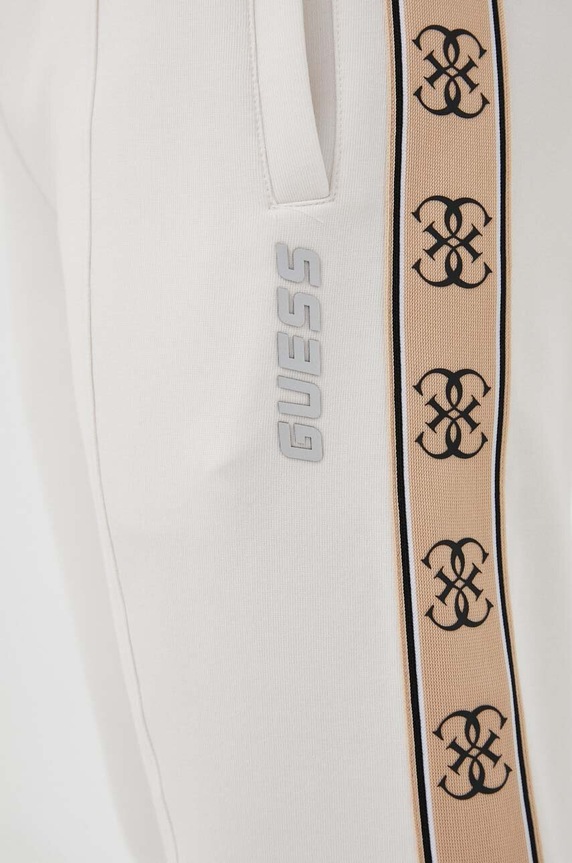 Guess spodnie dresowe MICKEY beżowy Z2YB09.KB3P2