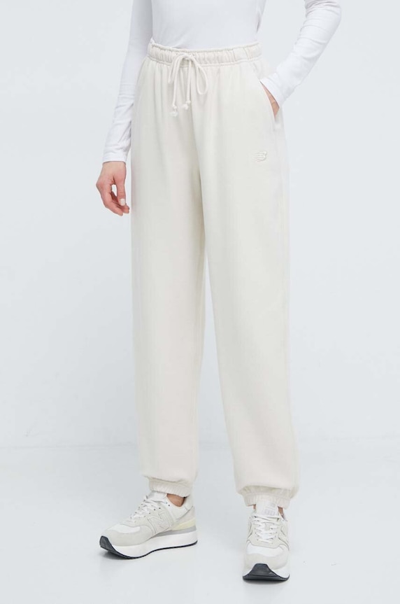 New Balance spodnie dresowe bawełniane WP41513LIN bawełna beżowy WP41513LIN
