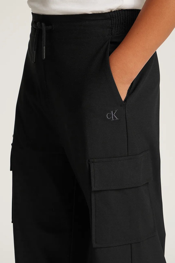 Dječji donji dio trenirke Calvin Klein Jeans DRY KNIT SKATER IB0IB02344.PPYA crna