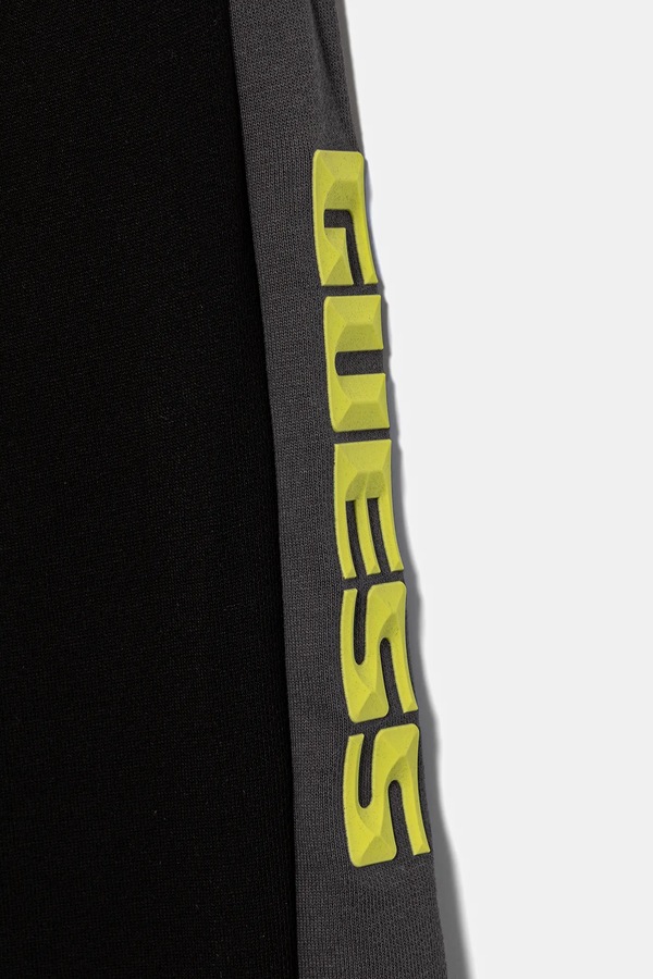 Дитячі бавовняні штани Guess колір чорний фото 2